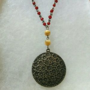 Red beaded necklace with vintage pendant